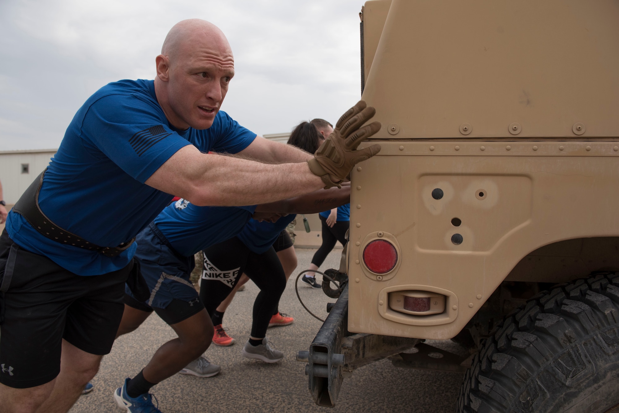 U.S. Air Force Airmen assigned to the 407th Expeditionary Security Forces Squadron push a Humvee during the Battle of the Badges event at Ahmed Al Jaber Air Base, Kuwait, Nov. 11, 2020.