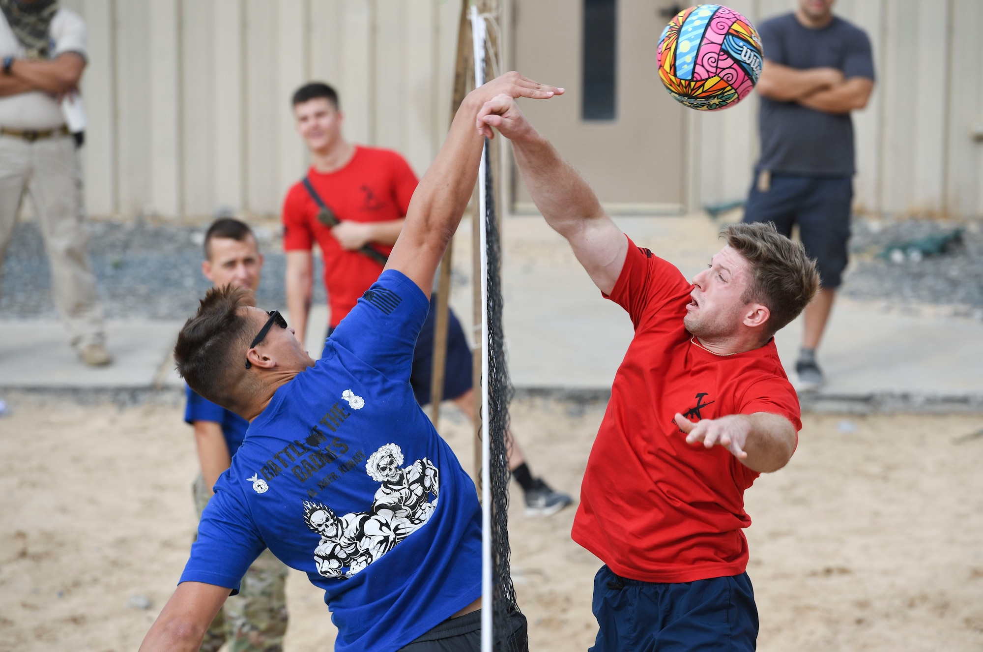 U.S. Air Force Airmen assigned to the 407th Expeditionary Security Forces Squadron and the 407th Civil Engineer Squadron play volleyball during the Battle of the Badges event at Ahmed Al Jaber Air Base, Kuwait, Nov. 11, 2020.