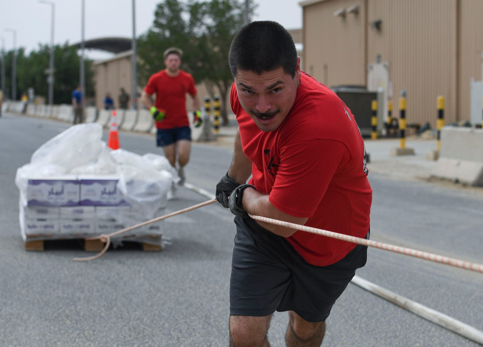 U.S. Air Force Senior Airman Shawn O’Rourke, 407th Expeditionary Civil Engineer Squadron driver operator, pulls a pallet of water during the Battle of the Badges event at Ahmed Al Jaber Air Base, Kuwait, Nov. 11, 2020.