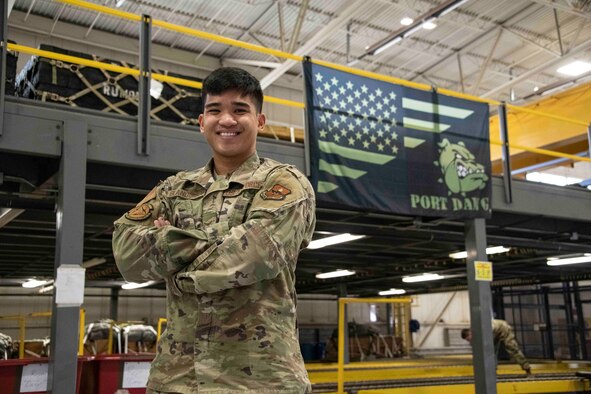 person stands infront of a flag