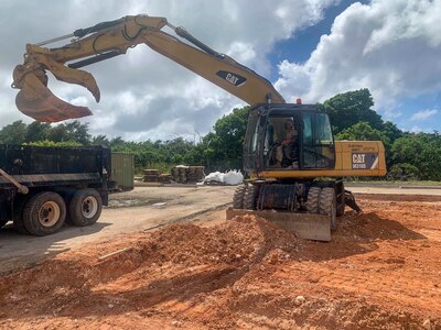 Equipment Operator Constructionman Christopher Strader from Angola, Ind., assigned to U.S. Naval Mobile Construction Battalion (NMCB) 3 Detail Guam, operates an excavator to begin excavating the grade beams for the construction of an Expedient Small Asset Protection Structure on Anderson Air Force Base to support training capabilities for the U.S. Air Force's 554th RED HORSE Squadron.