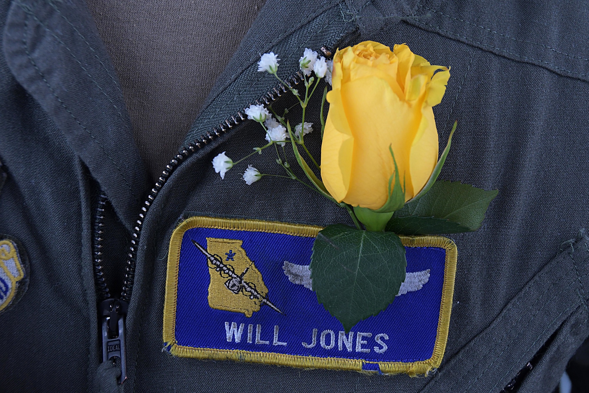 A yellow rose boutonniere sits above the name tape of Capt. Will Jones, 700th Airlift Squadron pilot, during a wedding ceremony on the back of a C-130H3 Hercules at Dobbins Air Reserve Base, Ga. on Nov. 10, 2020. He and 1st Lt. Lyndsy Harrison, a 700th Airlift Squadron navigator, came up with the idea to get married on the back of a C-130 to honor their love of aviation (U.S. Air Force photo/Andrew Park)