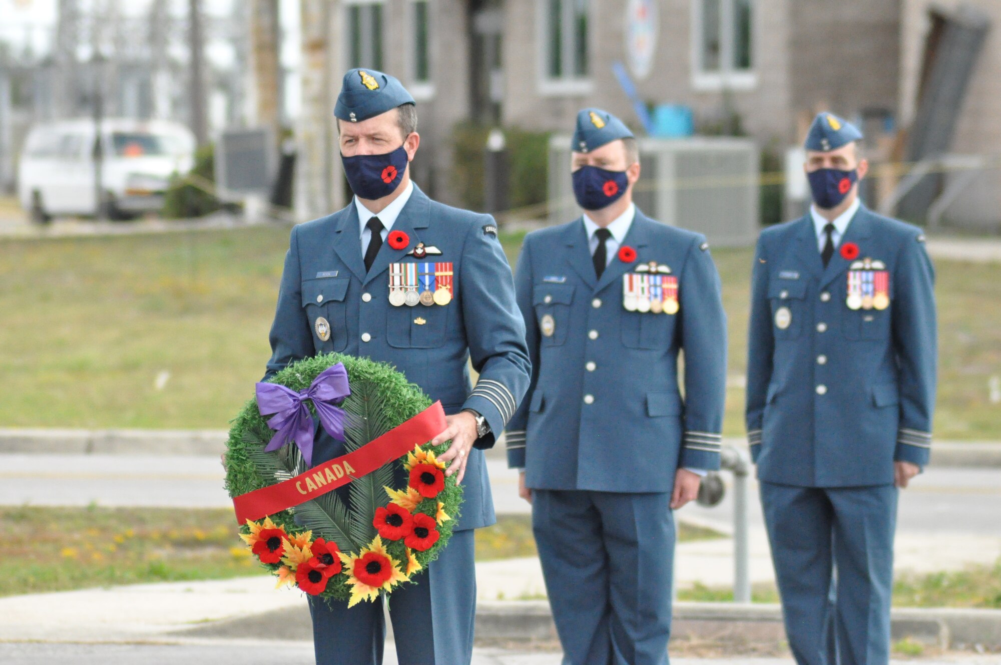 Canadian officers Col. Clay Rook, Lieutenant-Colonel Mark Hickey, and Maj Kevin Foster prepare to dedicate wreaths of remembrance on behalf of the Canadian Government, the Royal Canadian Airforce, and Canadian Detachment Tyndall, respectively at the Canadian Detachment Tyndall Remembrance (Veteran’s) Day parade at Tyndall Air Force Base, Fla.