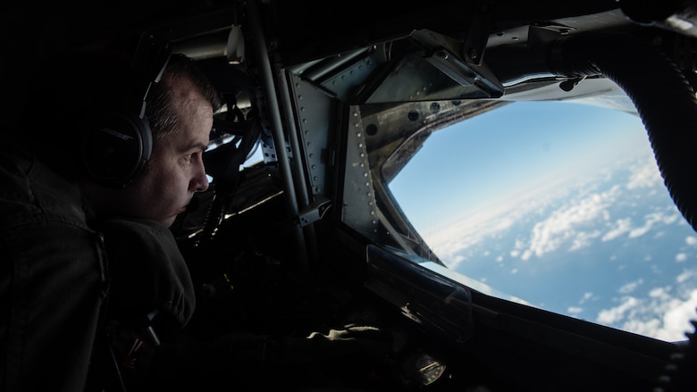 U.S. Air Force Tech. Sgt. Michael Weidman, 909th Aerial Refueling Squadron boom operator, scans the airspace for fuel receivers during a training sortie, Nov. 13, 2020, over the Pacific Ocean off the coast of Japan. The 909th ARS provided support to a B-1B Lancer Bomber Task Force mission, enabling deployed units to extend operational range, time on station, and integration throughout the U.S. Indo-Pacific Command area of responsibility. (U.S. Air Force photo by Staff Sgt. Peter Reft)