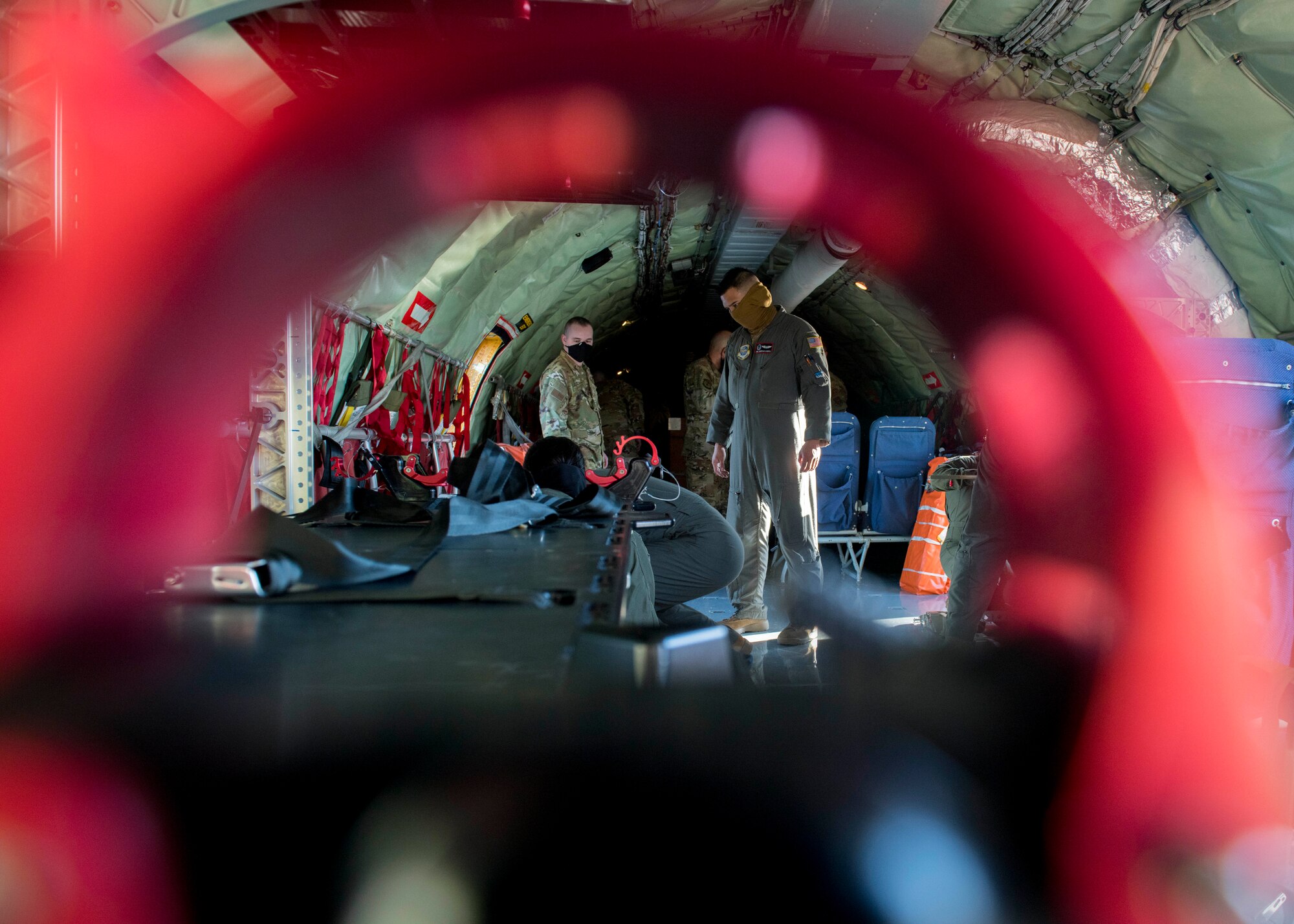 U.S. Air Force Senior Airman Matthew Baxter (left) and Senior Airman Jeremiah Guinto (right), 92nd Air Refueling Squadron boom operators, assist in configuring a KC-135 Stratotanker to conduct an aeromedical evacuation mission at Travis Air Force Base, California, Nov. 7, 2020. Airmen from Fairchild’s 92nd ARS, 93rd ARS, 384th ARS, 97th ARS and 92nd Aircraft Maintenance Squadron, conducted an aeromedical evacuation mission bringing patients in need of medical care from the Pacific back to the United States. (U.S. Air Force photo by Senior Airman Lawrence Sena)