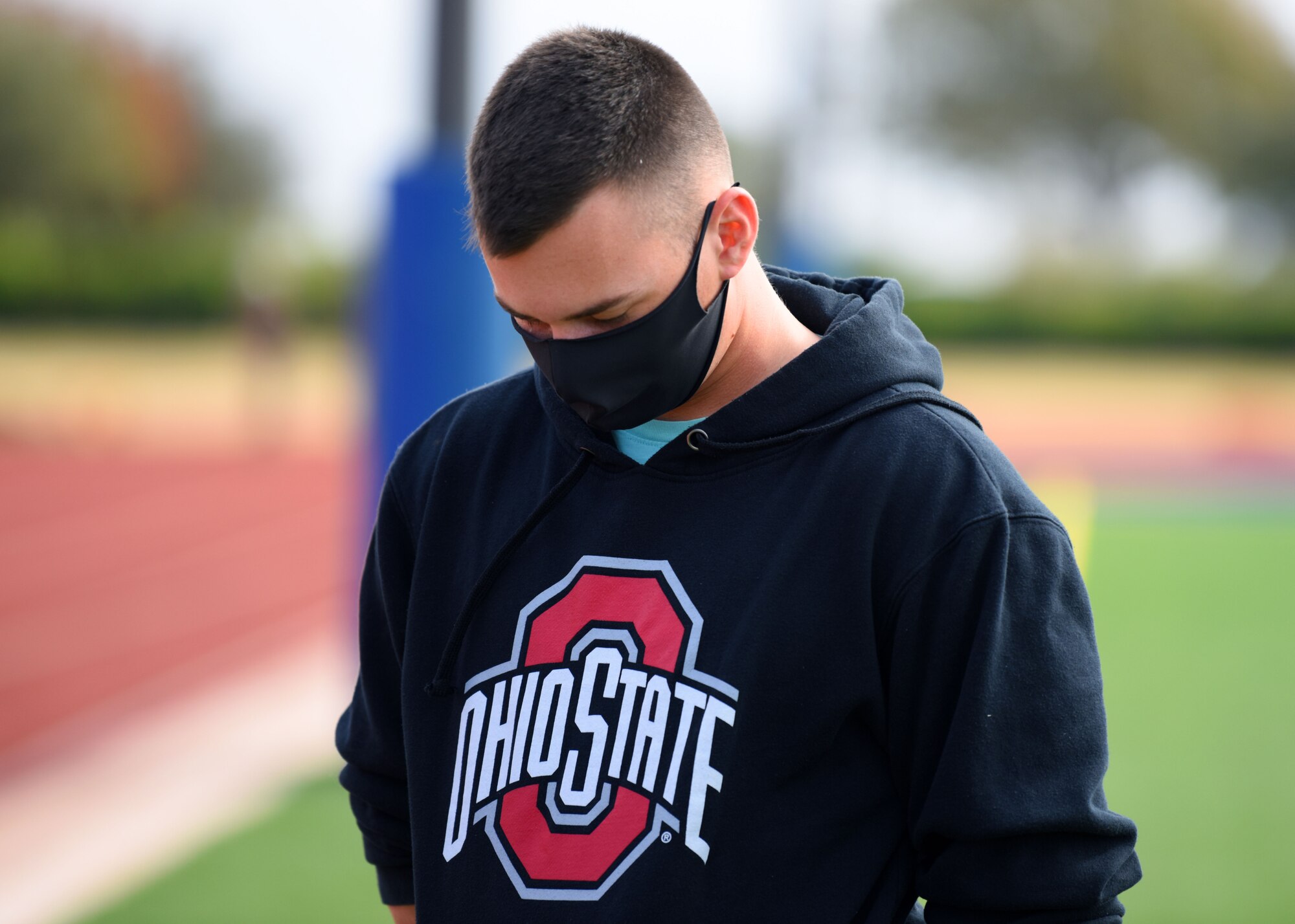 A 312th Training Squadron student bows his head during a moment of silence at the Prisoner of War and Missing in Action 24 hour remembrance run on the Mathis Fitness Center track on Goodfellow Air Force Base, Texas, Nov. 14, 2020. Over 1,500 American heroes are still missing and unaccounted for from the Vietnam War. (U.S. Air Force photo by Airman 1st Class Ethan Sherwood)