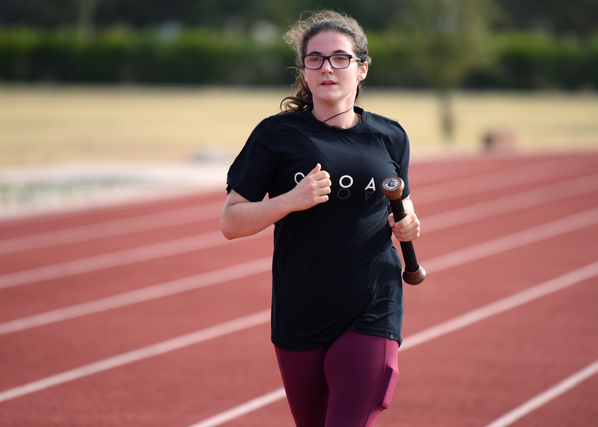 A participant runs with the Prisoner of War and Missing in Action baton during the POW-MIA 24 hour remembrance run at the Mathis Fitness Center track on Goodfellow Air Force Base, Texas, Nov. 14, 2020. Participants ran laps around the track for 24 straight hours. (U.S. Air Force photo by Airman 1st Class Ethan Sherwood)