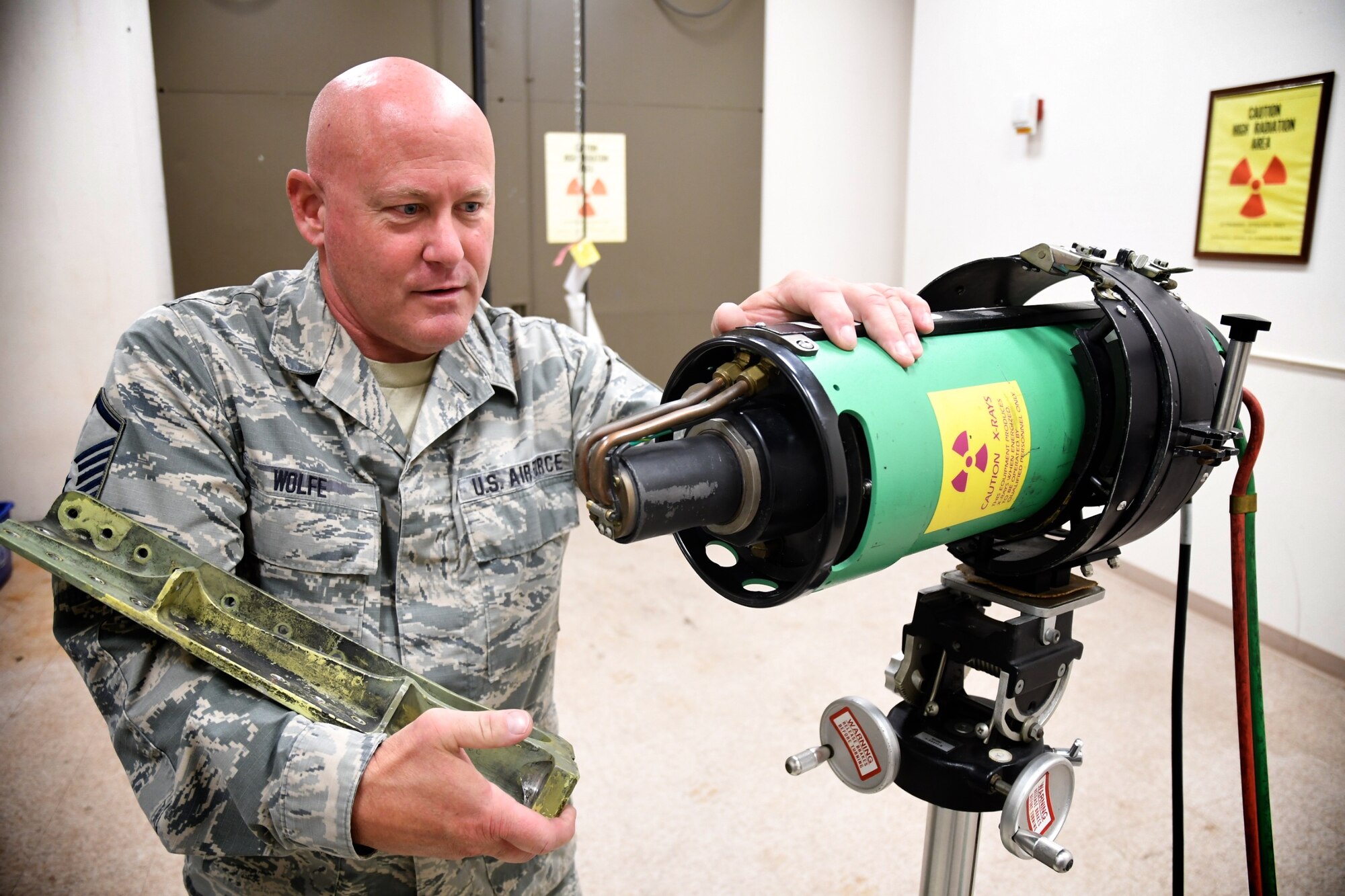 Master Sgt. David Wolfe helps prepare the 932nd Maintenance Squadron “NDI LAB” Non-Destructive Inspection shop for X-ray inspection. The technology saves time and money finding defects for the 932nd Maintenance Group at Scott Air Force Base, Ill.   “We use this whenever we get a part in or a weld certification, we take it and place the item under the x-ray tube head, secure the vault, and snap the picture.  Then we’ll take the film plate and run it through the processor so it’ll create an image off of the film plate onto a computer screen. Now we’re better able to interpret an image, whereas before we didn’t have that technology to where we could really highlight what we wanted to see and zoom in on,” Wolfe noted in a demonstration July 13, 2020 at Scott Air Force Base, Ill. (U.S. Air Force photo by Lt. Col. Stan Paregien)