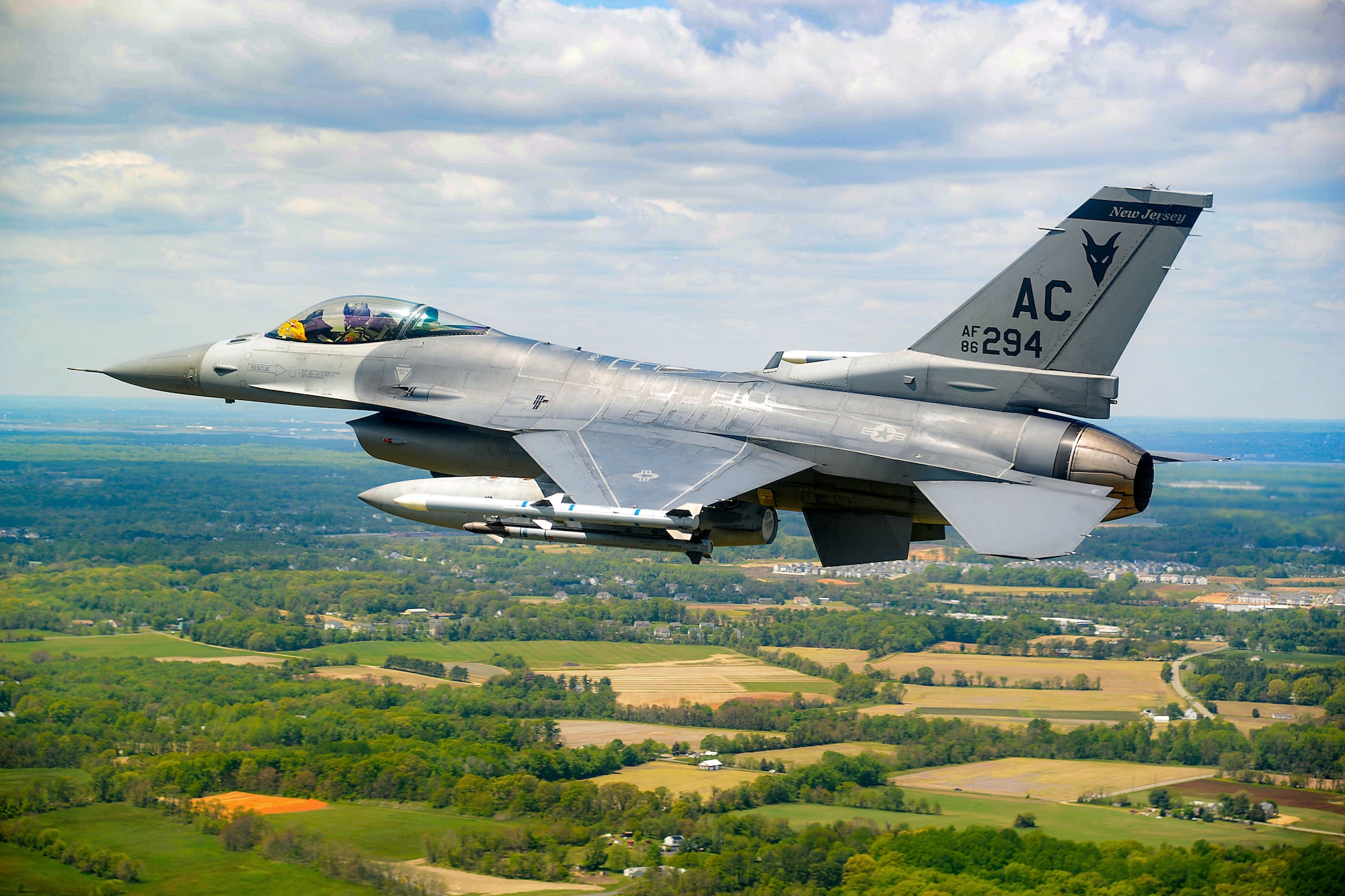 An image of a New Jersey Air National Guard F-16 Fighting Falcon flying.