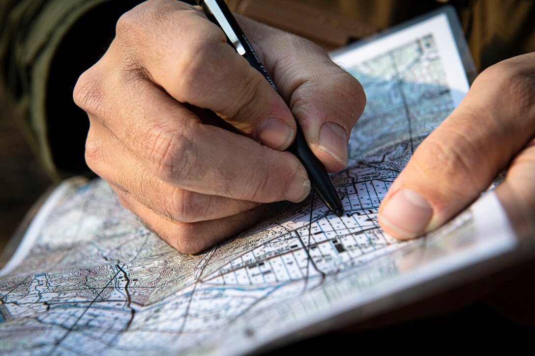 An Osan Air Base 25th Fighter Squadron A-10 Thunderbolt II pilot logs coordinates during combat survival training in the Republic of Korea, Nov. 12, 2020.  Osan’s 51st Fighter Wing Survival, Evasion, Resistance and Escape trainers tested the pilot’s ability to overcome high-risk situations in an unfamiliar environment. (U.S. Air Force photo by Senior Airman Greg Nash)