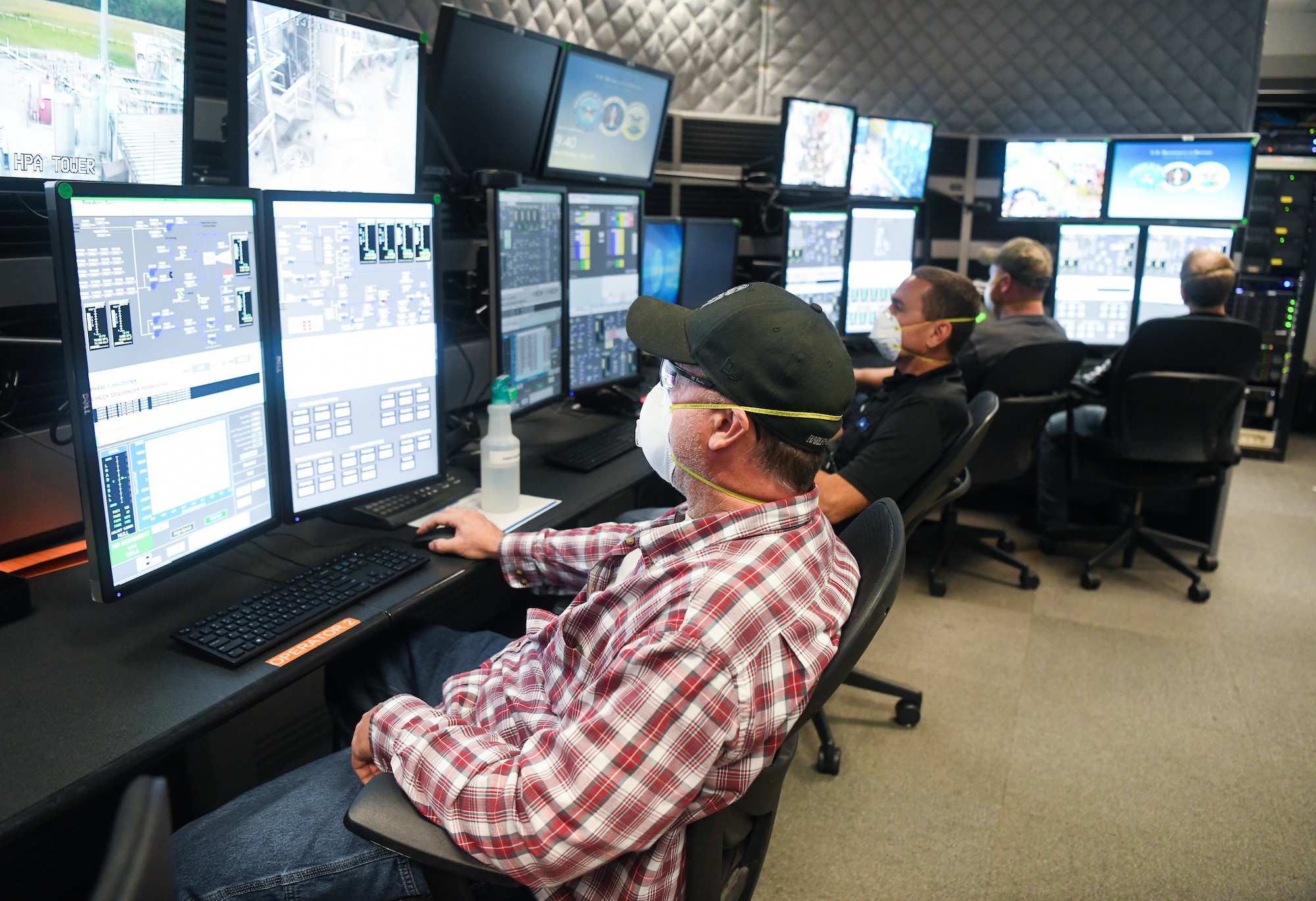 John VanScoten, left, an outside machinist, Daryl Osteen, a test operations engineer, and other Team AEDC personnel work in the control room of the Arnold Engineering Development Complex Aerodynamic and Propulsion Test Unit (APTU), May 20, 2020, while wearing masks to help mitigate risk associated with the coronavirus pandemic. The APTU team has performed their tasks, providing hypersonic testing capabilities, without interruption during the pandemic. Hypersonics is considered a critical field for national defense. (U.S. Air Force photo by Jill Pickett)