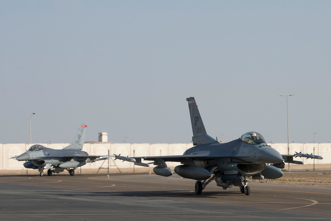 Two U.S. Air Force F-16 Fighting Falcons assigned to the 480th Fighter Squadron, 52nd Fighter Wing, Spangdahlem Air Base, Germany, taxi on the flightline upon arrival at Al Dhafra Air Base, United Arab Emirates, Nov. 12, 2020. Deploying as an instrument of Dynamic Force Employment, the contingent of F-16s and support personnel will rapidly integrate into theater air training, as well as joint, coalition and partnered missions in support of U.S. Air Forces Central and U.S. Central Command priorities. The dynamic deployment highlights the Air Force's ability to rapidly deploy and employ forces anywhere around the globe at any moment. (U.S. Air Force photo by Staff Sgt. Zade Vadnais)