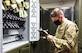 An Airman performs inventory check on weapons.
