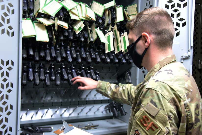 An Airman performs inventory on weapons.