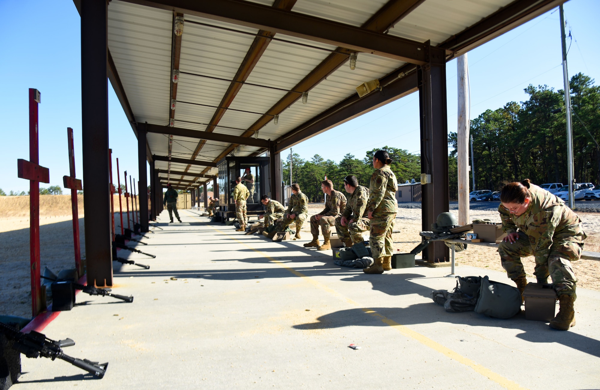 Multiple Airmen prepare for the M4 rifle qualification course.