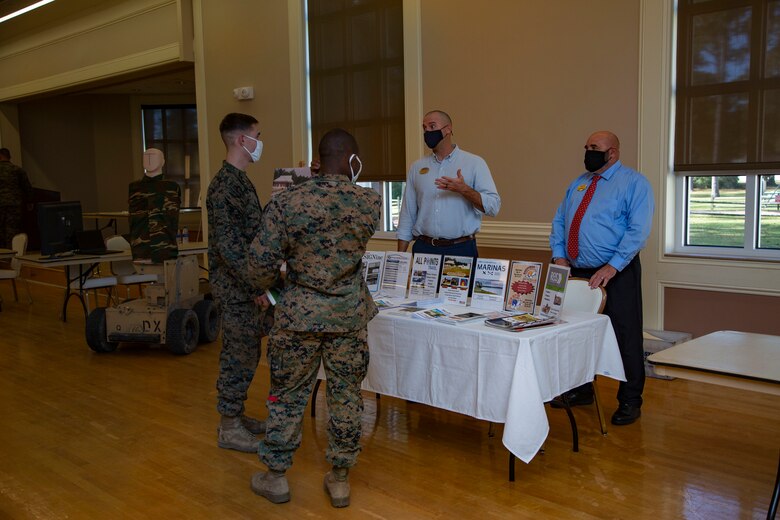 Mathew Cork, right, manager for Marathon Targets, informs Marines with 2nd Marine Division about the use of robotic targets during combat simulations for effective fire and movement during the Warfighter Training Symposium at Marston Pavilion on MCB Camp Lejeune, North Carolina, Nov. 4, 2020. The symposium provided more than 150 leaders with information on facilities available on MCB Camp Lejeune to Marines for training and provides an opportunity to inquire about range complex capabilities. (U.S. Marine Corps photo by Cpl. Ginnie Lee)