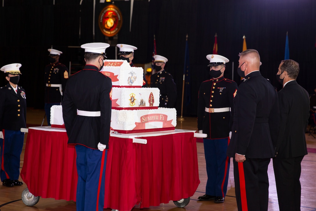 U.S. Marines prepare for the official cake cutting during the Marine Corps Installations East-Marine Corps Base Camp Lejeune cake cutting ceremony at the Goettge Memorial Field House on MCB Camp Lejeune, North Carolina, Nov. 10, 2020. Marines with MCIEAST-MCB Camp Lejeune celebrated the 245th Marine Corps birthday by reading the birthday message from Gen. John A. Lejeune, 13th Commandant of the Marine Corps and cutting the traditional birthday cake while adhering to COVID-19 mitigation protocols. (U.S. Marine Corps photo by Lance Cpl. Christian Ayers)