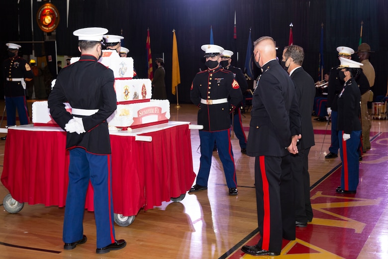 U.S. Marines prepare for the march off of the traditional cake during the Marine Corps Installations East-Marine Corps Base Camp Lejeune cake cutting ceremony, at the Goettge Memorial Field House on MCB Camp Lejeune, North Carolina, Nov. 10, 2020. Marines with MCIEAST-MCB Camp Lejeune celebrated the 245th Marine Corps birthday by reading the birthday message from Gen. John A. Lejeune, 13th Commandant of the Marine Corps and cutting the traditional birthday cake while adhering to COVID-19 mitigation protocols. (U.S. Marine Corps photo by Lance Cpl. Christian Ayers)
