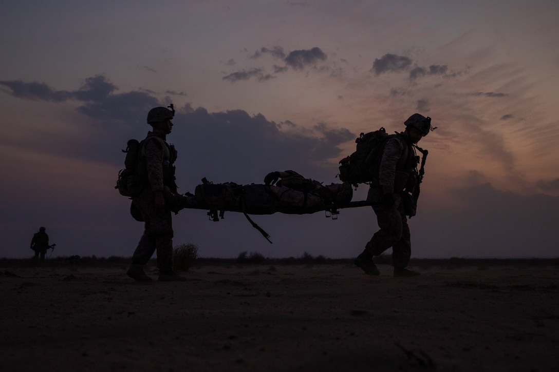 A U.S. Marine and U.S. Navy Corpsmen evacuate a simulated casualty during a Tactical Recovery of Aircraft and Personnel exercise in Kuwait, Nov. 11.