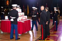 U.S. Marines prepare for the march off of the traditional cake during the Marine Corps Installations East-Marine Corps Base Camp Lejeune cake cutting ceremony, at the Goettge Memorial Field House on MCB Camp Lejeune, North Carolina, Nov. 10, 2020. Marines with MCIEAST-MCB Camp Lejeune celebrated the 245th Marine Corps birthday by reading the birthday message from Gen. John A. Lejeune, 13th Commandant of the Marine Corps and cutting the traditional birthday cake while adhering to COVID-19 mitigation protocols. (U.S. Marine Corps photo by Lance Cpl. Christian Ayers)