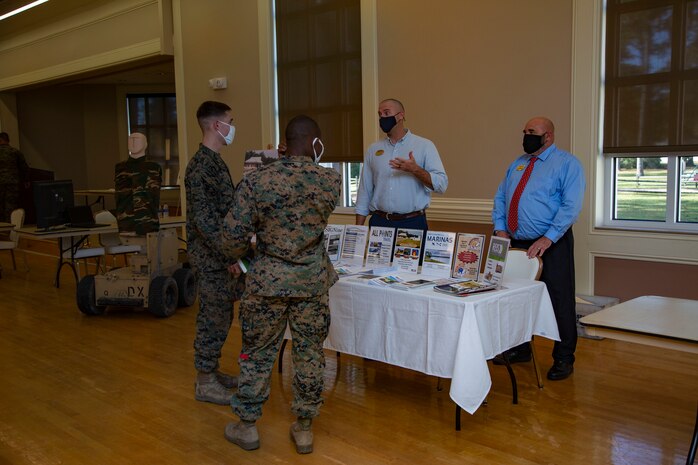 Mathew Cork, right, manager for Marathon Targets, informs Marines with 2nd Marine Division about the use of robotic targets during combat simulations for effective fire and movement during the Warfighter Training Symposium at Marston Pavilion on MCB Camp Lejeune, North Carolina, Nov. 4, 2020. The symposium provided more than 150 leaders with information on facilities available on MCB Camp Lejeune to Marines for training and provides an opportunity to inquire about range complex capabilities. (U.S. Marine Corps photo by Cpl. Ginnie Lee)