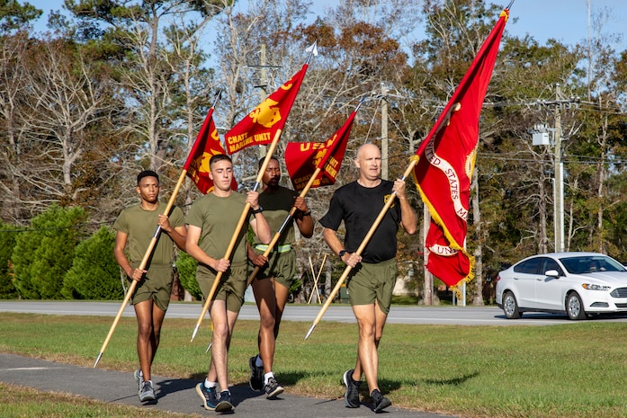 U.S. Marine Corps Master Gunnery Sgt. Robert K. Herrron, right, the maintenance chief for Center for Naval Aviation Technical Training (CNATT), leads Pfc. Ethan E. Cole, left, Pfc. Eric J. Fonseca, center left, and Pfc. Chris J. Traylor, center right, all students with CNATT, in a run to commemorate the Marine Corps Birthday on Marine Corps Air Station New River, North Carolina, Nov. 10, 2020. Marines on MCAS New River ran in teams for at least one mile to reach a total of 245 miles in honor of the 245th Marine Corps Birthday. (U.S. Marine Corps Photo by Lance Cpl. Isaiah Gomez)