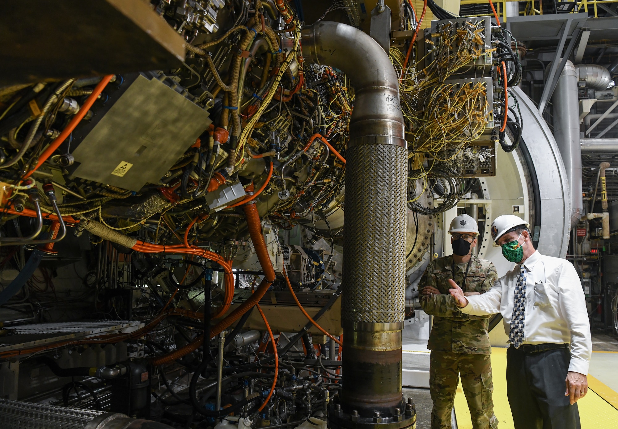 Jeff Albro, right, Joint Strike Fighter Joint Program Office F135 ground test and evaluation manager, speaks with Lt. Col. Lane Haubelt, Materiel leader for the Arnold Engineering Development Complex Aeropropulsion Ground Test Branch, as they and others tour the J2 test cell with an F135 engine installed, Sept. 2, 2020, at Arnold Air Force Base, Tenn. Testing of a new rotor design, also tested in a Sea Level test cell, is continuing in J2 after an outage. (U.S. Air Force photo by Jill Pickett)