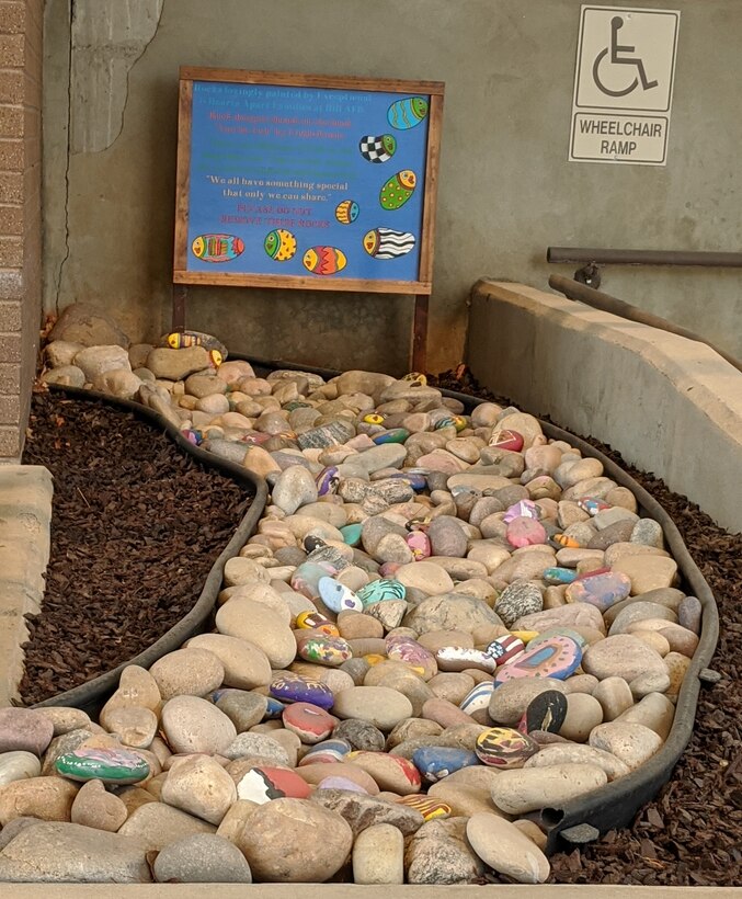 A rock garden filled with painted rocks displayed outside the Airman and Family Readiness Center.