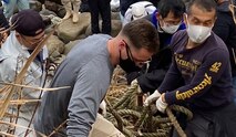 A Soldier from the 14th Missile Defense Battery at the Kyogamisaki Communication Site at Kyotango-Shi, Japan, hauls out trash as part of a community cleanup of Suisho-hama Beach, Nov 8. The battery, operated by the U.S. Army Space and Missile Defense Command’s 1st Space Brigade, does almost monthly cleanups of surrounding beaches during the warm months of the year. (Courtesy photo by Katsuro Shintaro)