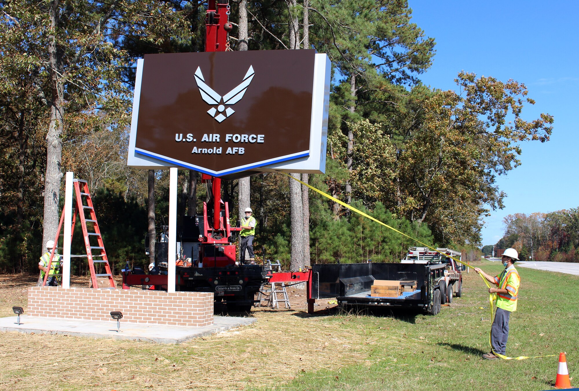 The new sign at the Main Gate at Arnold Air Force Base, Tenn., is installed Oct. 22, 2020. Located alongside Wattendorf Highway before entering the base, the new sign was necessary after an accident occurred in February 2020, in which a car ran off the roadway and collided with the previous sign. The project was completed by the Simplified Acquisition Base Engineering Requirements (SABER) contractor, SDVE, LLC. (U.S. Air Force photo by Deidre Moon)