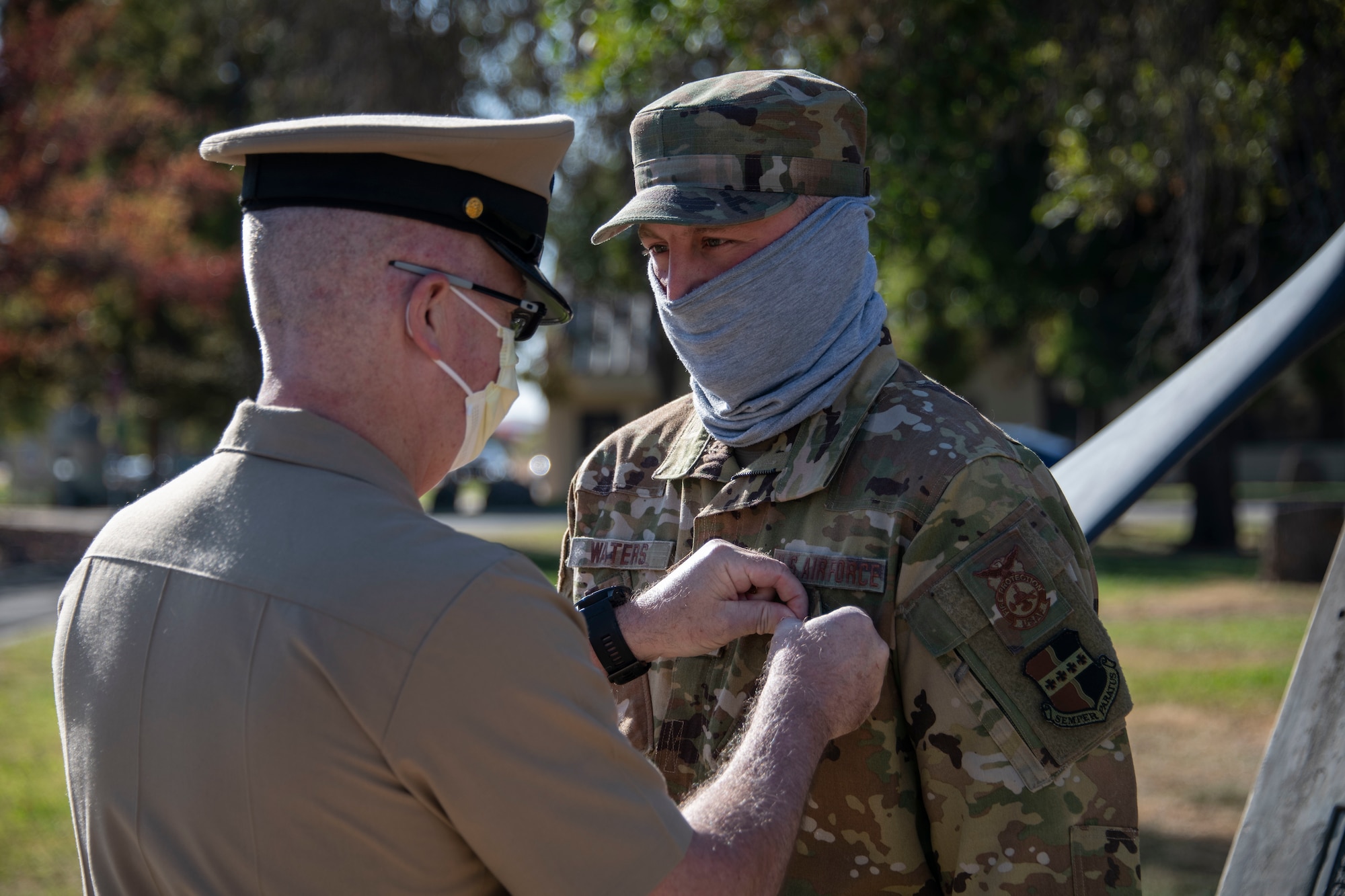 Chief Petty Officer James Amentler pins the Navy and Marine Corps Achievement Medal on Staff Sgt. Thomas Waters