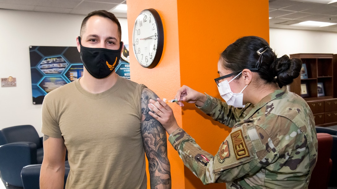 Master Sgt. Chad Hardesty, 412th Security Forces Squadron, receives the flu vaccine from Senior Airman Natalie Avalos, 412th Medical Group, at Edwards Air Force Base, California, Nov. 13. (Air Force photo by Giancarlo Casem)