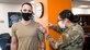 Master Sgt. Chad Hardesty, 412th Security Forces Squadron, receives the flu vaccine from Senior Airman Natalie Avalos, 412th Medical Group, at Edwards Air Force Base, California, Nov. 13. (Air Force photo by Giancarlo Casem)