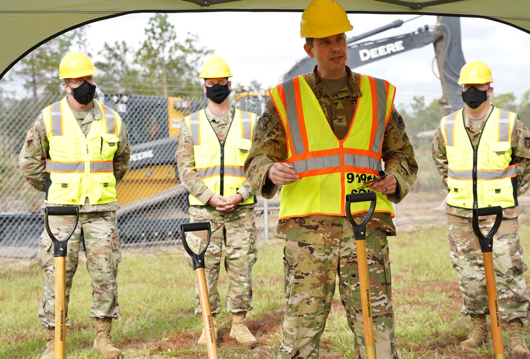 Photo of 919 SOW commander standing next to a shovel while speaking