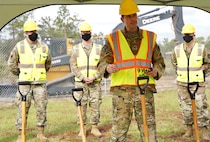 Photo of 919 SOW commander standing next to a shovel while speaking