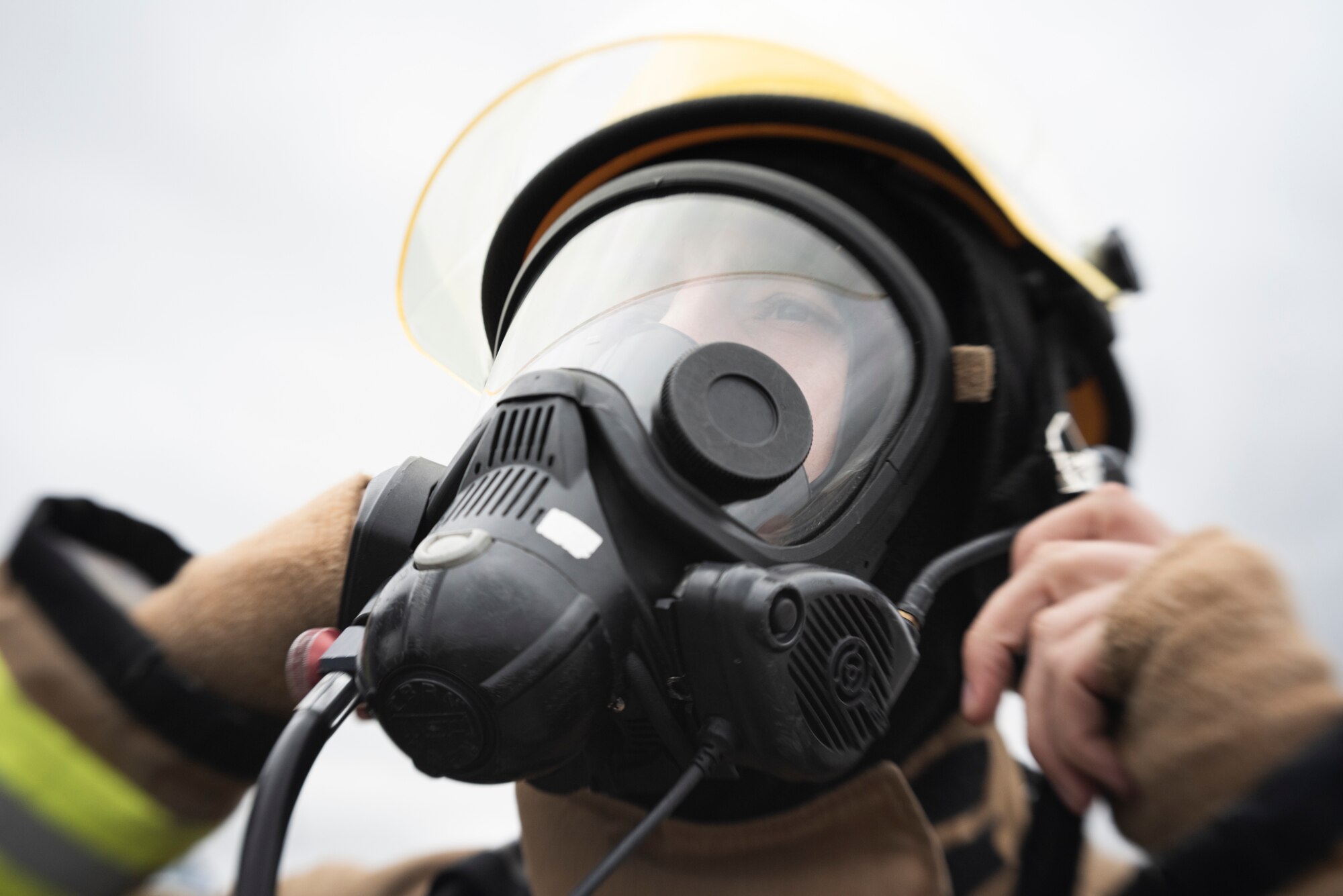 Robert Fisher, 422d Fire Emergency Services firefighter, dons his breathing apparatus prior to beginning airfield firefighting training at RAF Fairford, England, Oct. 23, 2020. This training ensures that firefighters from the 422d Fire Emergency Services are prepared for any potential incidents at the airfield. (U.S. Air Force photo by Tech. Sgt. Aaron Thomasson)