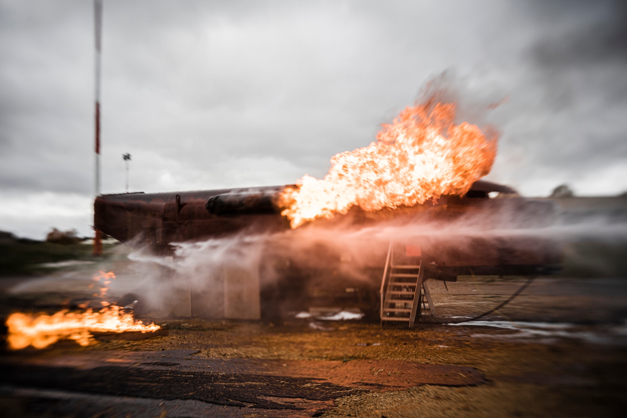 The 422d Fire Emergency Services uses its new Rosenbauer PANTHER vehicle to extinguish fires on its mobile aircraft trainer at RAF Fairford, England, Oct. 23, 2020. The trainer allows firefighters to practice fighting fires both inside and outside an aircraft. (U.S. Air Force photo by Tech. Sgt. Aaron Thomasson)