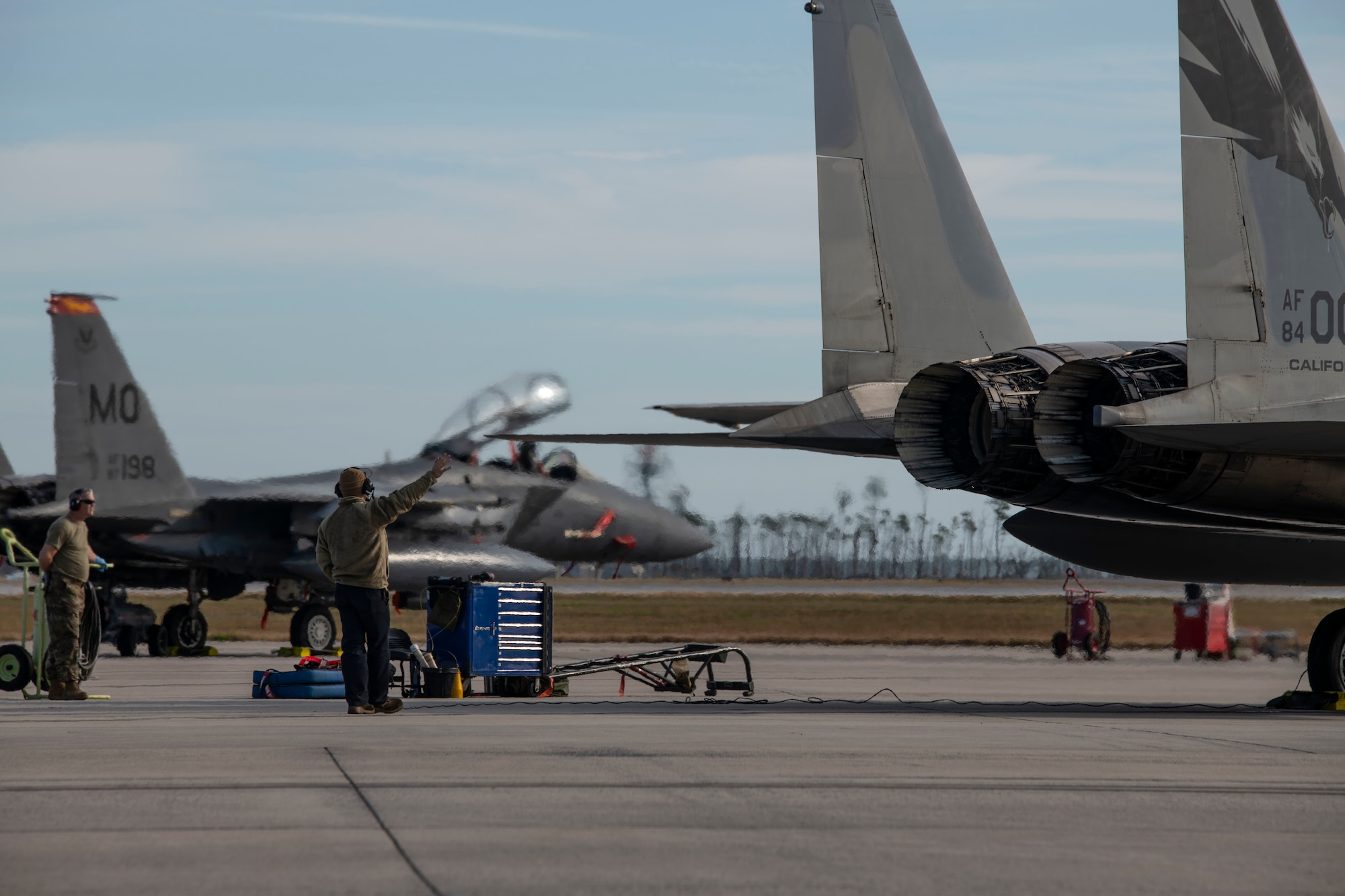 man and planes on flight line
