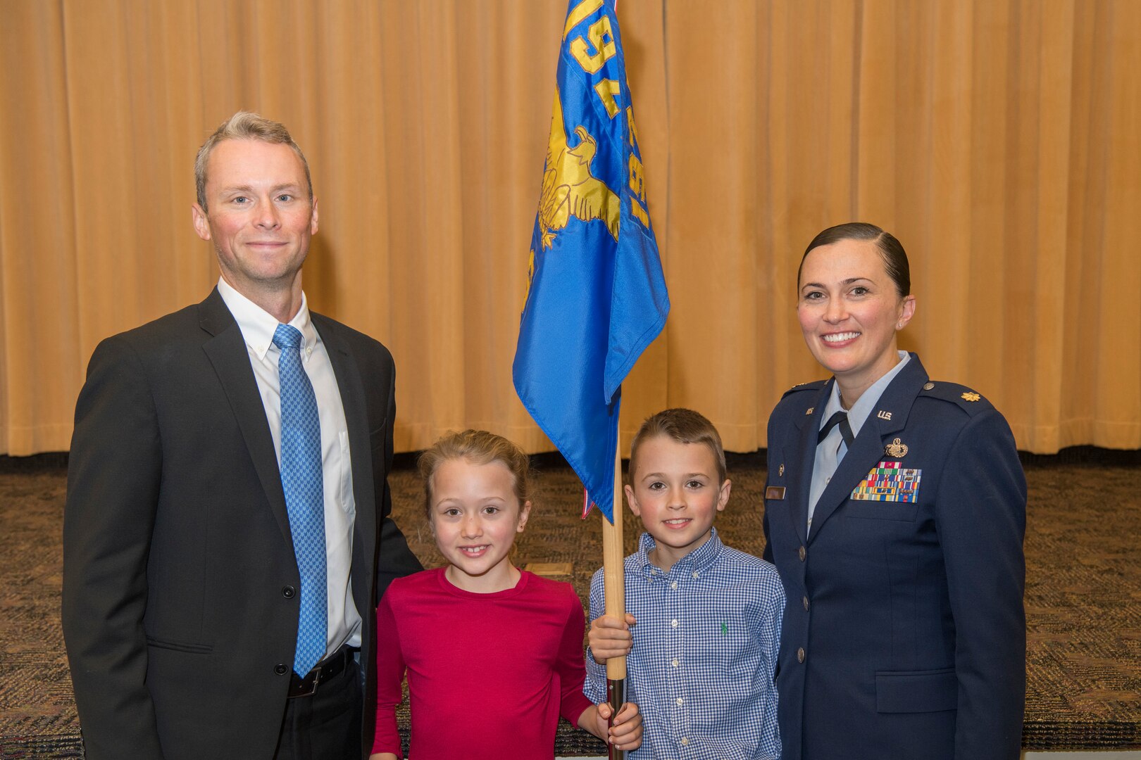 An Airman poses for a photo with her family