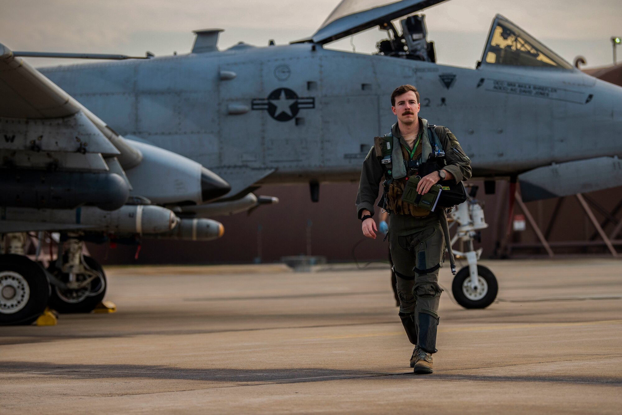 A pilot walks on the flightline