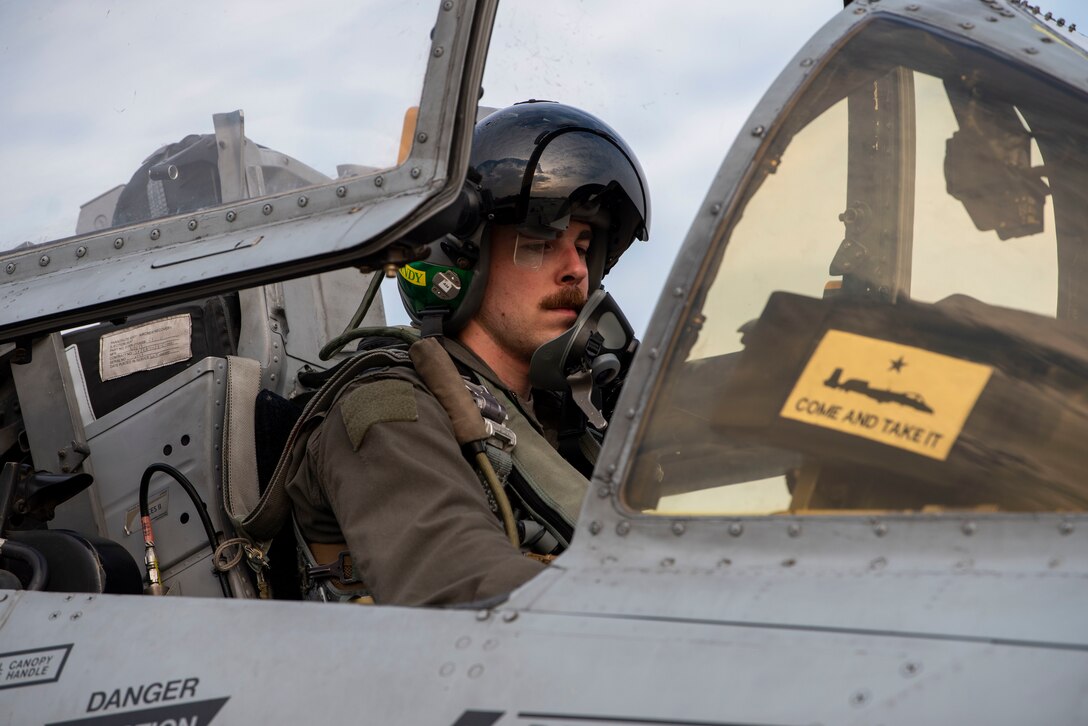 A pilot sits in the cockpit of an A-10