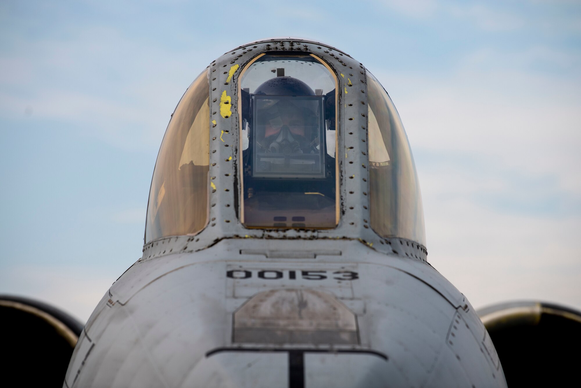 An pilot sits in the cockpit of an A-10