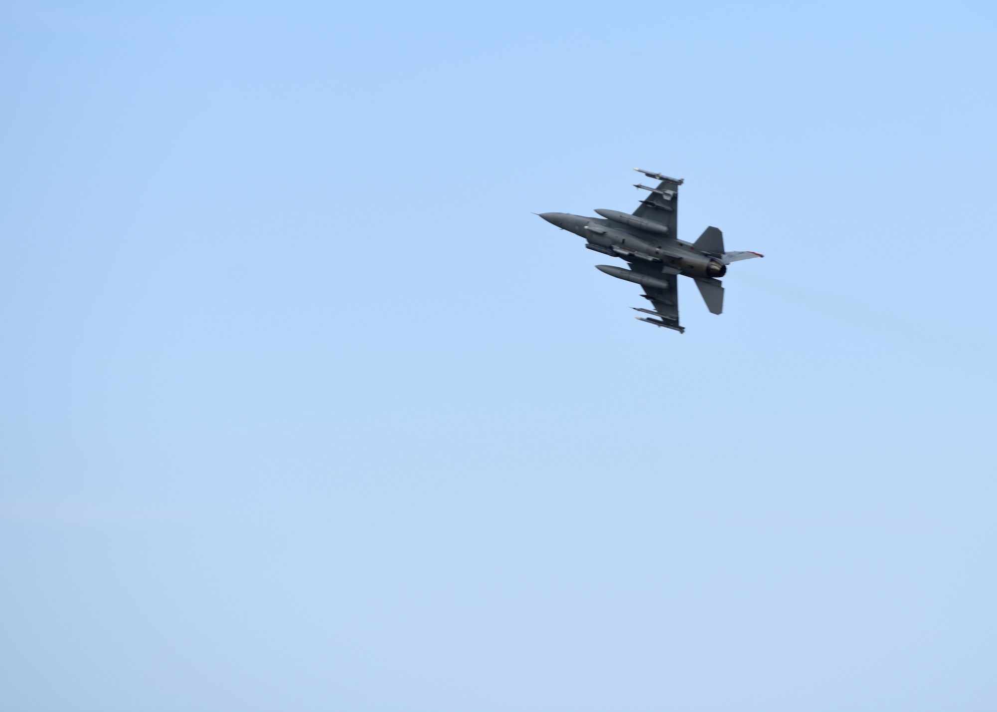 An F-16 Fighting Falcon flies by the runway before coming in for a landing after a Bomber Task Force mission at Misawa Air Base, Japan, Nov. 13, 2020. Bomber Task Force missions demonstrate U.S. commitment to allies and partners throughout the Indo-Pacific area of responsibility and the ability of Air Force Global Strike Command to deliver lethal strike options for combatant commanders at a moment’s notice. (U.S. Air Force photo by Branden Yamada)