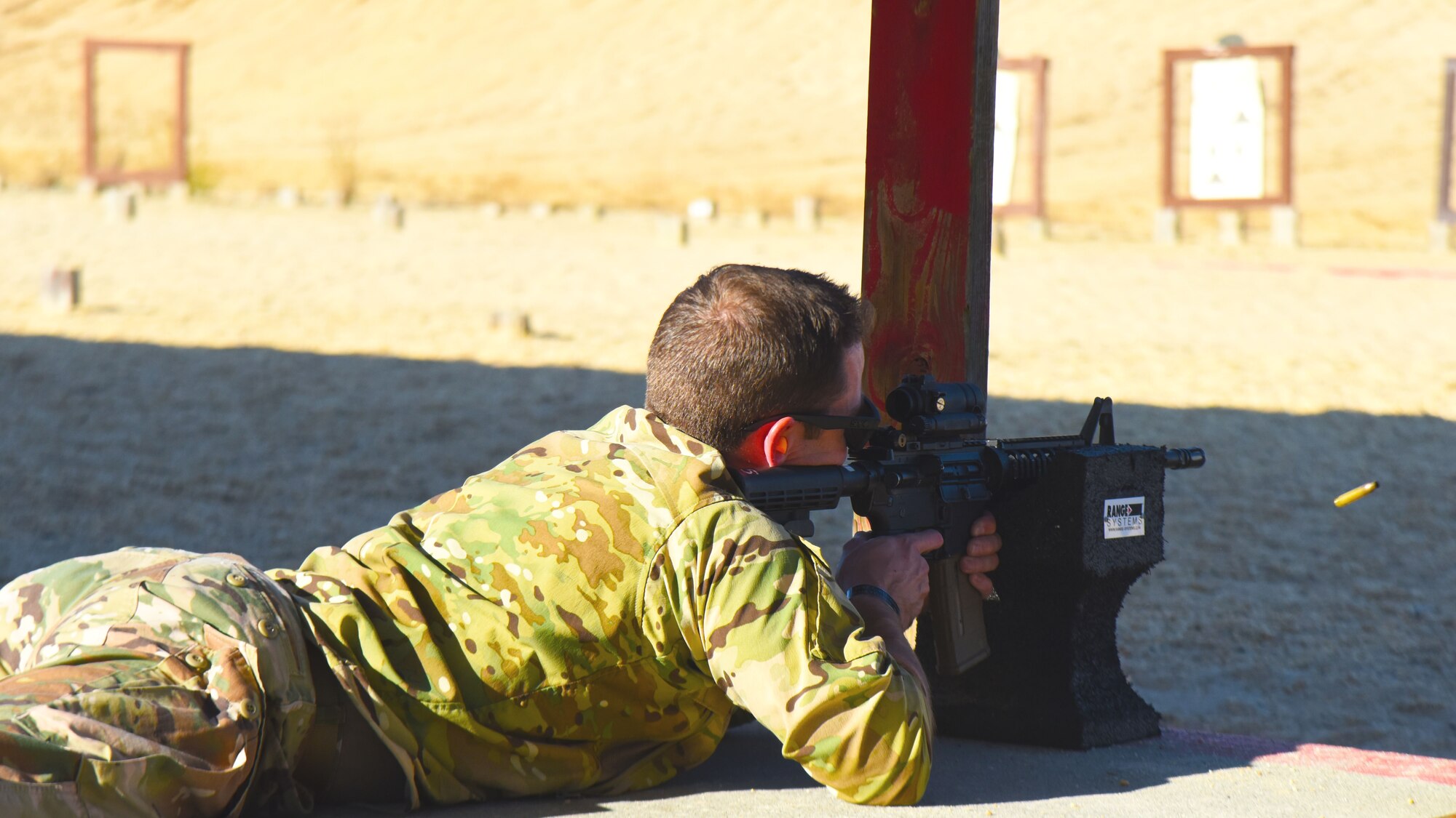 A participant in the M4 qualification course fires his M4 rifle at the U.S. Army Support Activity training range, Nov. 6, 2020, on Joint Base McGuire-Dix-Lakehurst, N.J. This qualification course will prepare Airmen for deployment operations in the future. (U.S. Air Force photo by Daniel Barney)