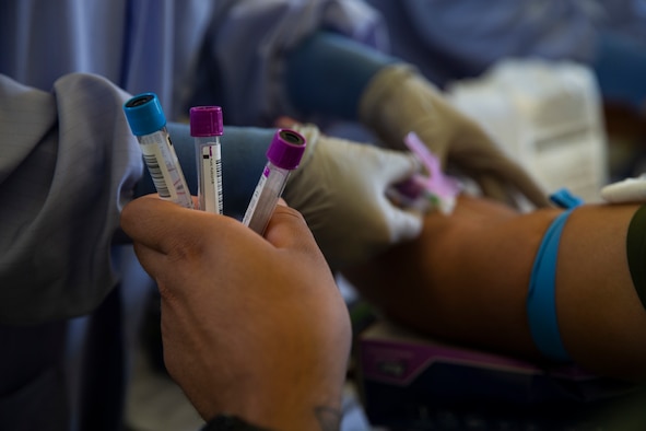 Close-up of a technician drawing blood.