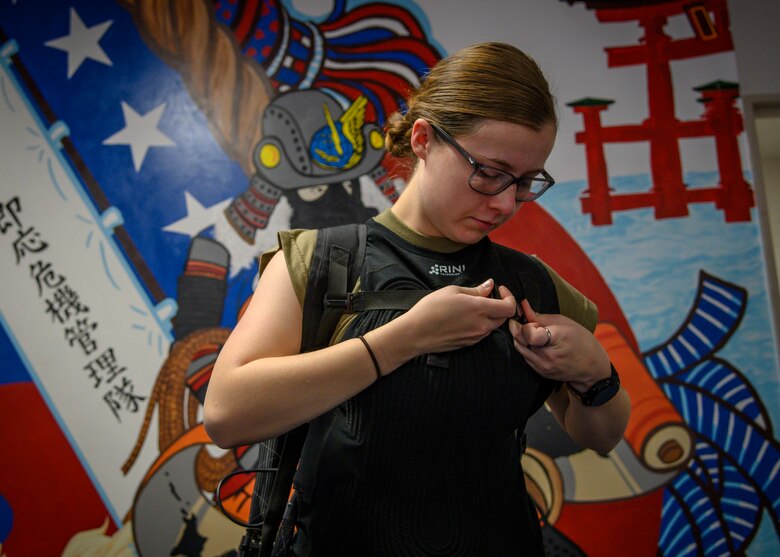 U.S. Air Force Airman 1st Class Tiffany Eustice, a 35th Civil Engineer Squadron emergency manager, puts on the cooling vest at Misawa Air Base, Japan, Nov. 12, 2020. Airmen are potentially exposed to high heat-stress environments and the vest allows for constant cooling of the Airmen’s core temperatures ensuring Airmen can safely execute the mission. (U.S. Air Force photo by Airman 1st Class China M. Shock)