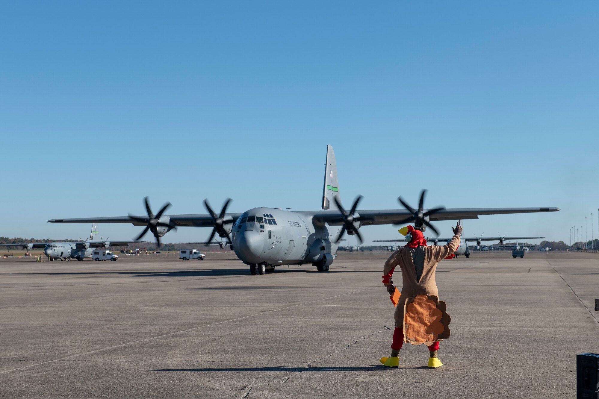 Man in Turkey suit marshals out a C-130J