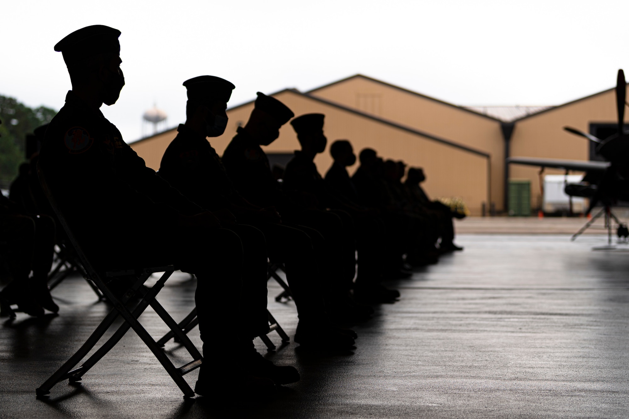 A photo of attendees watching a ceremony