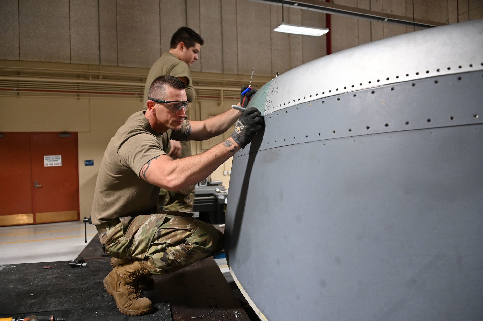 Senior Master Sgt. James Jenkins, aircraft structural technician with the 507th Maintenance Squadron, marks areas to be trimmed from a new engine intake section fabricated in the 507th Maintenance Squadron structures shop October 2, 2020, at Tinker Air Force Base, Oklahoma. The structures shop fabricated a part in-house following a bird strike, saving the Air Force more than $1 million. (U.S. Air Force photo by Master Sgt. Grady Epperly)