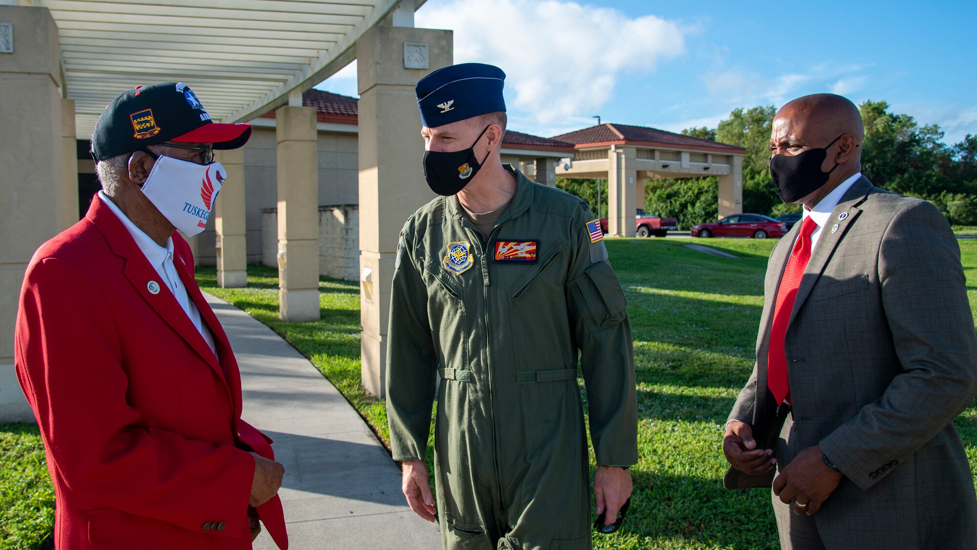 U.S. Army Air Forces Sgt. Thomas Newton, a Documented Original Tuskegee Airman, and his son Retired U.S. Air Force Tech. Sgt. Stevie Carmack, talk with U.S. Air Force Col. Benjamin Jonsson, the 6th Air Refueling Wing commander, at MacDill Air Force Base, Fla., Nov. 10, 2020.